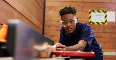 Carpenter Using Plane In Woodworking Woodshop
